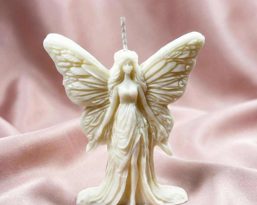Vela escultural de cera blanca con forma de hada de pie y alas detalladas