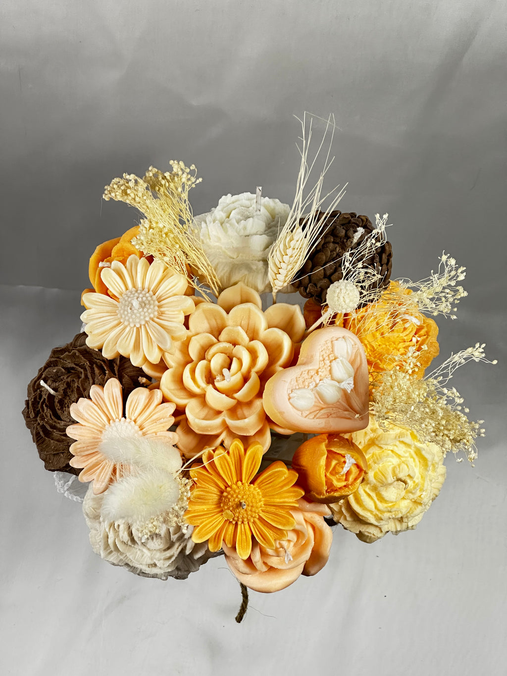 Detalle del ramo de velas de cera vegetal. Flores, piñas y espigas en tonos cálidos. Souvenir de lujo artesanal, perfecto para regalos estacionales y eventos temáticos.